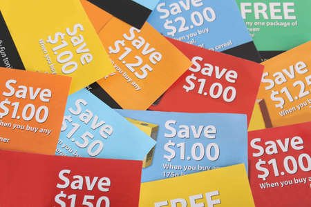 Cutting coupons in different colors, and price ranges from free to a few dollars (short depth of field)の写真素材