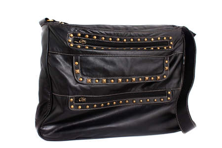 Woman's black leather back with gold colored studs on a white backgroundの写真素材
