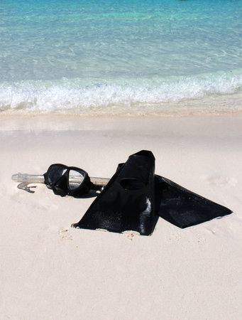 Snorkeling equipment on the sandy shore of a tropical beach