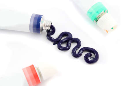 Dark blue  artist's oil paints spilling out onto a white  background (Not Isolated )の写真素材
