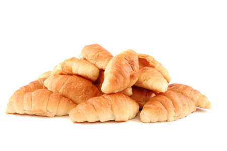 Golden croissants fresh from the bakery on a white backgroundの写真素材