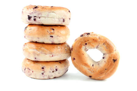 Pile of blueberry bagels on a white background. の写真素材