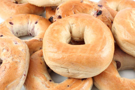Pile of blueberry and cinnamon raisin bagels on a white background. の写真素材