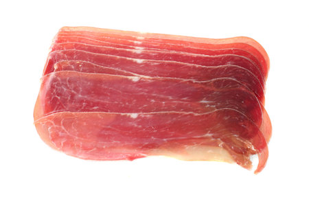 Italian delicacy prosciutto ham slices isolated on a white backgroundの写真素材