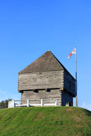Forth Howe, the site of an 18th and 19th century British Army fortification on a hill in Saint John, New Brunswick, Canada surrounded by blue sky with waving flagの写真素材