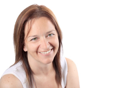 Pretty brunette adult woman in her early forties smiling happily on a white background