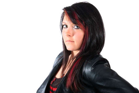 Pretty brunette teenage girl with red streaks in her hair and leather jacket on a white backgroundの写真素材