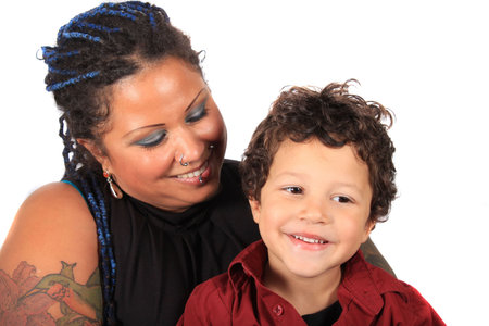 Single mother looks lovingly at her multiracial son on a white backgroundの写真素材