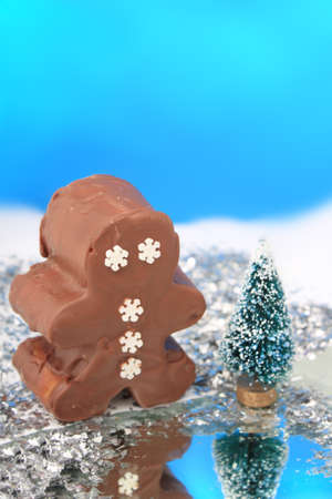 Fantasy chocolate fudge snowman in wonderland with frozen pond and snowの写真素材