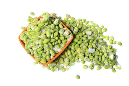 Frozen edamame also known as soybeans in a bowl on a white backgroundの写真素材