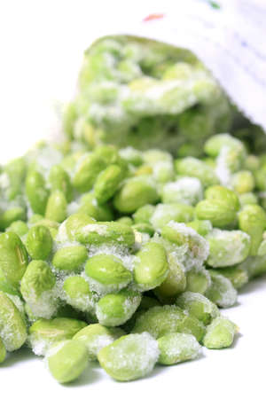 Frozen edamame also known as soybeans in a bag on a white backgroundの写真素材