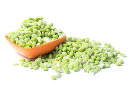 Frozen edamame also known as soybeans in a bowl on a white backgroundの写真素材