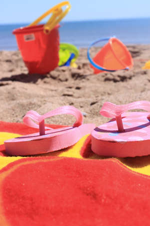 Colorful beach toys and towel in the sandy shores of Panmure Island in Prince Edward Island, Canadaの写真素材