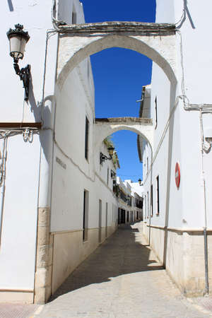 Narrow cobblestone street with arches in Osuna; Andalusia; Spainの写真素材