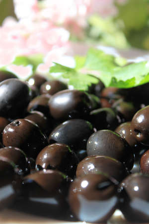 Kalamata or black olives glistening in the light, very shallow depth of fieldの写真素材