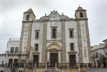 Church in Praca do Giraldo, Evora, Alentejo, Portugal, Europe, under dark rainy skies
