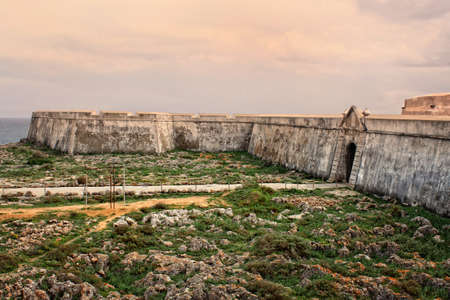 Rugged terrain surround the fortress in Ponta de Sagres, Algarve, Portugal  の写真素材