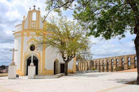 Beautiful white and yellow quaint church in Elvas, in front of The Aquaduct, Elvas