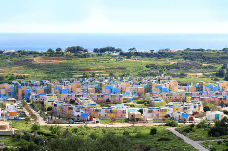 Colorful houses in a community in Albufeira  with the Atlantic ocean in the background, Algarve, Portugalの写真素材