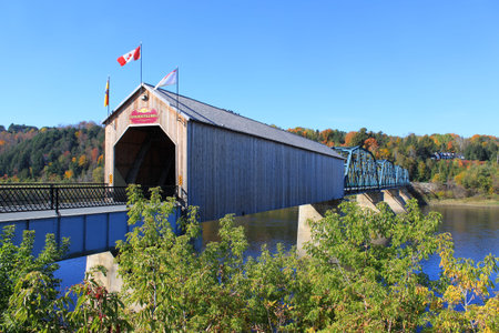 Wooden covered Bridge in Florenceville, New Brunswick, Canada with colorful Autumn trees in the...