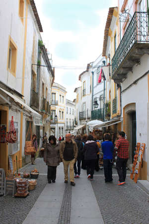 EVORA,PORTUAL-APRIL18,2013:  Rua 5 de Outoubro, the street most catered to tourism selling art, crafts and souvenirs, as crowds walk along the storefronts in Evora, Portugal, April 18, 2013のeditorial素材