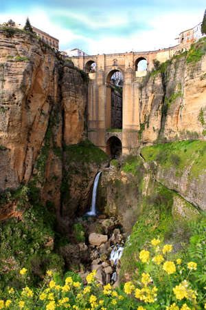 Puente Nuevo bridge at evening time in Ronda with waterfall, Andalucia, Spainの写真素材