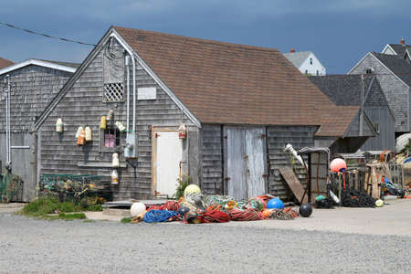 Wooden fishing shack with buoys hanging and colorful ropes in Peggy's Cove, Nova Scotia, Canadaの写真素材