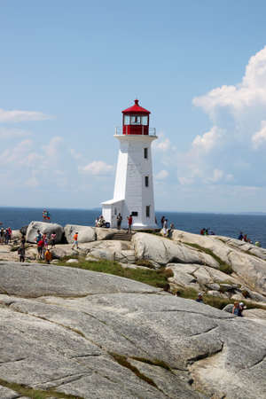  Peggy's Cove, Nova Scotia, August 6, 2014, : People walking around  the lighthouse in touristic Peggy's Cove, Nova Scotia, Canada のeditorial素材