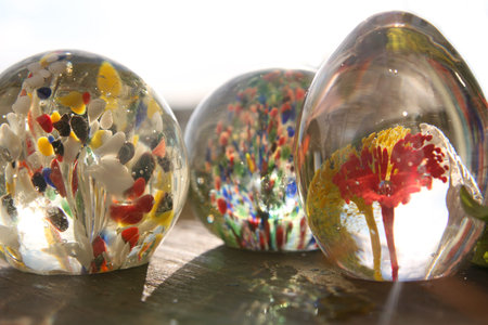 Three vintage colorful glass blown paper weights from the seventies