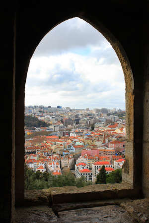 Looking at Lisbon's rooftops through a medieval windowのeditorial素材