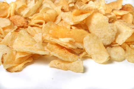 kettle chips spilling over on a white background kettle chips spilling over on a white background