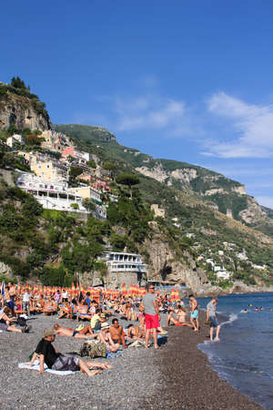 POSITANO, ITALY - JUNE 27, 2015: People enjoying the Mediterranean beach in Positano on the Amalfi Coast of Italyのeditorial素材