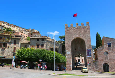 ASSISI, ITALY - JUNE 24, 2014: Fortified entrance to the town of Assisi Italy showing houses on steep hillのeditorial素材