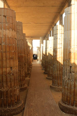 SAQQARA, EGYPT, JANUARY 31, 2016: People visiting the ruins in the Saqqara, entering and exiting through its main entranceway with large Roman pillars along the walkwayのeditorial素材