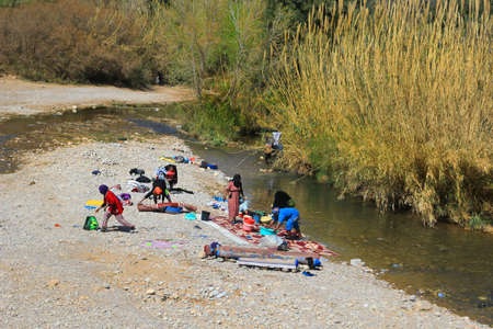 MOROCCO, AFRICA - MARCH 2, 2016: Women washing their clothes on a small river in Morocco, Africaのeditorial素材