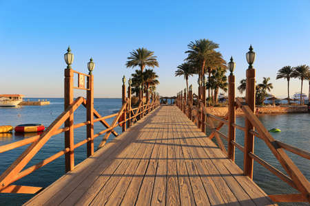 Long wooden boardwalk with lamposts on a sunny day in Hurghada, Egyptのeditorial素材