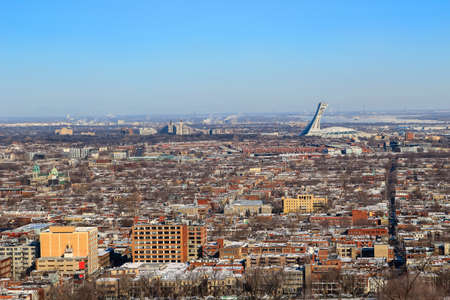 View from top of hill overlooking houses and stadium in the city of Montreal, Quebec, Canadaの写真素材