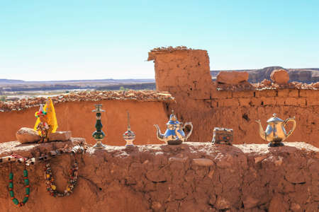 Wares for sale showcased on the walls along the Beautiful and colorful ochre village of Ait Benhaddou a ksar  in Moroccoの写真素材