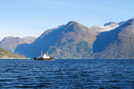 Ship on the water with Scenery of water and surrounding mountains  of Sognefjord, Norway, Scandinaviaの写真素材