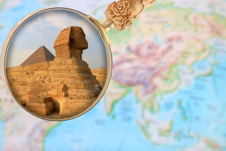 Looking in on The Sphinx and Pyramid at Giza with a magnifying glass or loop over an atlas in Egypt,...