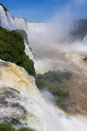 Iguazu Falls or IguaÃ§u Falls are waterfalls of the Iguazu River on the border of the Argentine province of Misiones and the Brazilian state of Parana, with colorful rainbowの写真素材