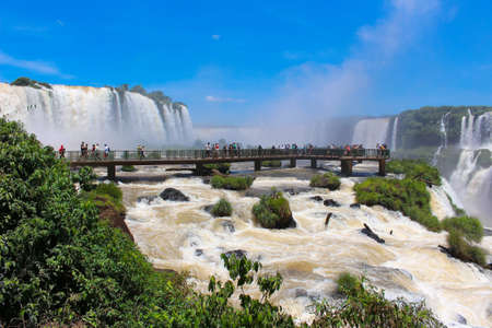 Iguazu Falls or IguaÃ§u Falls -  2018-01-31: People admiring the waterfalls of the Iguazu River on the border of the Argentine province of Misiones and the Brazilian state of Parana, they make up the largest waterfall system in the world.のeditorial素材