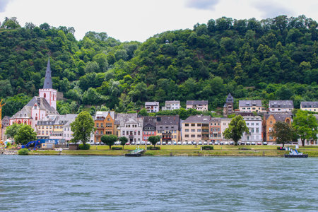 Small town with church along the shore of the Rhine river in Germany, Europe