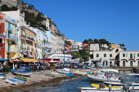 Capri, Italy 2015-06-27 Busy beach with boats docked and people walking in the island of Capri , Italyのeditorial素材