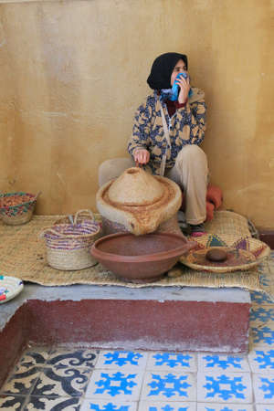Marrakesh, Morocco - 2016-03-02 : Woman working to grind argan nuts to make oil, butters and other products, near Marrakesh, Morocco, Africaのeditorial素材