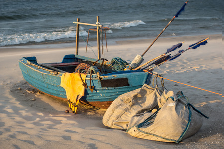 Fishing boat on a beach during sunset. Baltic Sea and the Hel Peninsula in KuÅºnica, Poland.の写真素材