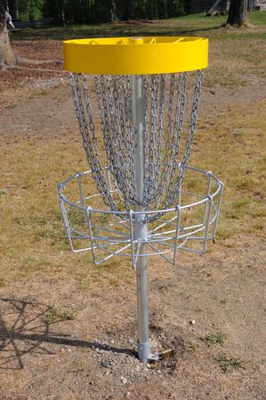 Disc Golf Target in a field near the forestの写真素材