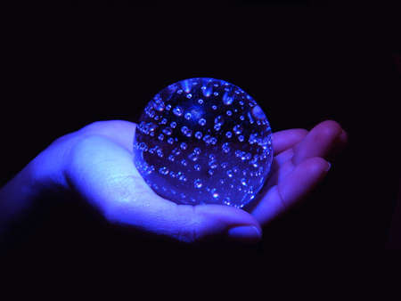 Blue Sphere Over a Handの写真素材