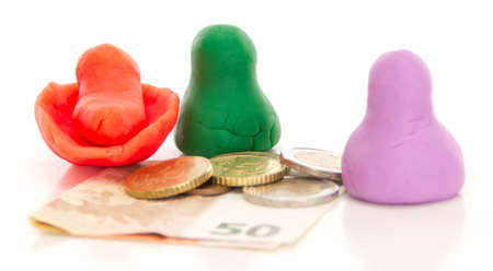 Modelling clay figures with moneyの写真素材