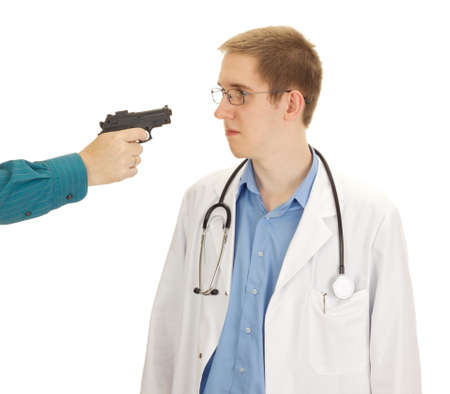 A person hold the young doctor at gunpointの写真素材